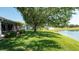 Large backyard offering a blend of lush greenery and tranquil pond views at 15038 Tamarind Loop, Spring Hill, FL 34609