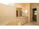 Bright bathroom featuring tub and double sink vanity at 15038 Tamarind Loop, Spring Hill, FL 34609