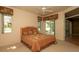 Cozy bedroom featuring a large window overlooking a serene lake view at 15038 Tamarind Loop, Spring Hill, FL 34609