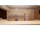 A well-lit kitchen featuring white appliances and cabinets with a breakfast bar area overlooking the dining room at 15038 Tamarind Loop, Spring Hill, FL 34609