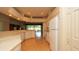 Bright kitchen featuring white cabinets, laminate floors, and a view into the back patio and the community at 15038 Tamarind Loop, Spring Hill, FL 34609