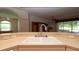 Open kitchen design featuring a dual bowl sink and a view of the Gathering room and outdoor screened patio at 15038 Tamarind Loop, Spring Hill, FL 34609