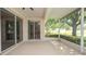 Screened-in lanai providing a view of the lake and trees at 15038 Tamarind Loop, Spring Hill, FL 34609