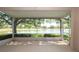 Screened-in lanai providing a panoramic view of the lake and golf course at 15038 Tamarind Loop, Spring Hill, FL 34609