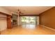 Spacious living room with wood floors and large sliding glass doors offering scenic views at 15038 Tamarind Loop, Spring Hill, FL 34609