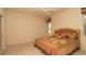 Main bedroom with large window, ceiling fan, and soft color palette at 15038 Tamarind Loop, Spring Hill, FL 34609