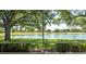 Scenic view of the lake and lush green golf course from screened lanai at 15038 Tamarind Loop, Spring Hill, FL 34609