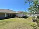Spacious backyard features a well-maintained lawn and tropical landscaping at 15585 Rene Ct, Brooksville, FL 34604