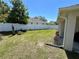 Green backyard features a privacy fence and newly mulched flowerbeds along the fence line at 15585 Rene Ct, Brooksville, FL 34604