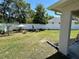 Backyard features a privacy fence, green grass, a shade tree, and a sunshade at 15585 Rene Ct, Brooksville, FL 34604