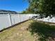 Backyard with privacy fence, tree, and newly mulched flowerbeds along the fence line at 15585 Rene Ct, Brooksville, FL 34604