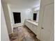 Bathroom with double sinks, tile flooring, and a large mirror at 15585 Rene Ct, Brooksville, FL 34604