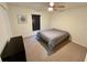 Bedroom features carpet flooring, ceiling fan, and a large window with dark wood blinds at 15585 Rene Ct, Brooksville, FL 34604