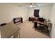 Bedroom features a ceiling fan, a wooden desk, and carpet flooring at 15585 Rene Ct, Brooksville, FL 34604