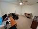 Bedroom with ceiling fan, carpet flooring, and plenty of space for a work area at 15585 Rene Ct, Brooksville, FL 34604