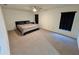 A simple bedroom featuring a queen bed, carpeted floors, neutral walls, and natural light from the windows at 15585 Rene Ct, Brooksville, FL 34604