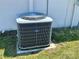 Exterior shot of an air conditioning unit located near the wall of the property at 15585 Rene Ct, Brooksville, FL 34604