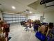 A well-lit garage featuring an insulated steel garage door, and an automatic garage door opener at 15585 Rene Ct, Brooksville, FL 34604