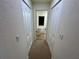 Hallway with carpet flooring and dual doors at 15585 Rene Ct, Brooksville, FL 34604