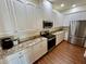 Well-equipped kitchen features stainless steel appliances, granite countertops, and ample white cabinetry at 15585 Rene Ct, Brooksville, FL 34604