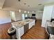 Bright kitchen island with a granite countertop, stainless steel appliances, and views into the living room at 15585 Rene Ct, Brooksville, FL 34604