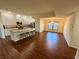 Well-lit kitchen with granite countertops, stainless appliances and adjoining dining area with chandelier at 15585 Rene Ct, Brooksville, FL 34604