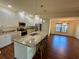 Beautiful kitchen with a large island, granite countertops, stainless steel appliances, and pendant lighting at 15585 Rene Ct, Brooksville, FL 34604