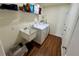 A laundry room equipped with a washer, dryer, utility sink, and wire shelving for storage at 15585 Rene Ct, Brooksville, FL 34604