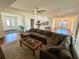 Open-concept living space features a large sectional sofa and seamless flow into the kitchen and dining area at 15585 Rene Ct, Brooksville, FL 34604