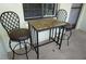 Cozy outdoor seating area with a small table and two comfortable chairs on a private balcony at 1881 Mazo Mnr # I-6, Lutz, FL 33558