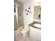 Nautical-themed bathroom featuring a shower, toilet, and a sink with a decorative ship wheel accent at 1881 Mazo Mnr # I-6, Lutz, FL 33558