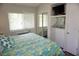 Well-lit bedroom with mirrored closet doors, a mounted TV, and a large window providing natural light at 1881 Mazo Mnr # I-6, Lutz, FL 33558