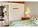 Cozy bedroom features a comfortable bed, a wooden nightstand with a lamp, and a view into the kitchen at 1881 Mazo Mnr # I-6, Lutz, FL 33558