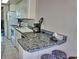 Compact kitchen with white cabinetry, dark countertops, and standard appliances at 1881 Mazo Mnr # I-6, Lutz, FL 33558