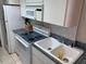 Functional kitchen features a stainless steel sink, range, and ample counter space at 1881 Mazo Mnr # I-6, Lutz, FL 33558