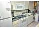 Practical kitchen with a stove, microwave, and ample countertop space for cooking at 1881 Mazo Mnr # I-6, Lutz, FL 33558