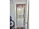 A compact laundry closet featuring a stacked washer and dryer unit for efficient space utilization at 1881 Mazo Mnr # I-6, Lutz, FL 33558