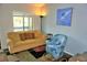 Inviting living room with natural light, a comfy sofa, and a stylish accent chair at 1881 Mazo Mnr # I-6, Lutz, FL 33558