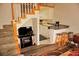 View of living room with staircase and partial kitchen view with breakfast bar at 1881 Mazo Mnr # I-6, Lutz, FL 33558