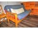 Casual living area with a futon and wooden chair, offering a relaxing space at 1881 Mazo Mnr # I-6, Lutz, FL 33558
