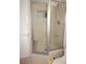 Tiled shower with a glass door and a built-in seat, providing a comfortable bathing experience at 1881 Mazo Mnr # I-6, Lutz, FL 33558