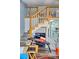 Lofted space above the kitchen with a visible stairway and a workout bench on the lower floor at 1881 Mazo Mnr # I-6, Lutz, FL 33558