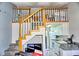A stairway view leading to a lofted space above the kitchen with white appliances at 1881 Mazo Mnr # I-6, Lutz, FL 33558