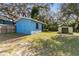 Backyard features two sheds, enclosed fence, and mature foliage at 1916 & 1910 Beachway Ln, Odessa, FL 33556