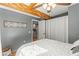 Bedroom with wooden ceiling beams, opening to the kitchen and closet at 1916 & 1910 Beachway Ln, Odessa, FL 33556