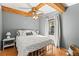 Bedroom with wooden ceiling beam and white iron bed frame at 1916 & 1910 Beachway Ln, Odessa, FL 33556