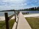 Beautiful lake view with a wooden dock extending into the water, perfect for fishing and relaxation at 1916 & 1910 Beachway Ln, Odessa, FL 33556