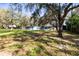 Charming home features a spacious lawn, mature trees, and inviting exterior, perfect for enjoying the outdoors at 1916 & 1910 Beachway Ln, Odessa, FL 33556