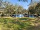 This property features multiple buildings with an expansive, tree-filled lawn, offering a serene and private setting at 1916 & 1910 Beachway Ln, Odessa, FL 33556