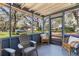 Screened porch with seating, providing a comfortable outdoor living space with neighborhood views at 1916 & 1910 Beachway Ln, Odessa, FL 33556